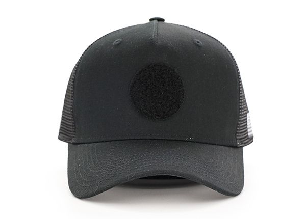 Front of All Black Trucker Hat With a Black Velcro Logo & a American Flag Logo on Side