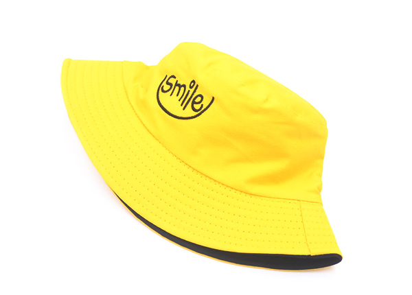 Front of Reversible Yellow Bucket Hat with a Smile Logo