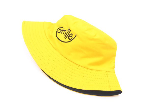 Front of Reversible Yellow Bucket Hat with a Smile Logo