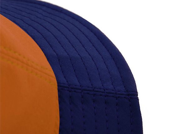 Brim of Orange Cotton Anime Bucket Hat Featuring a Chinese Word Logo and a Navy Brim 